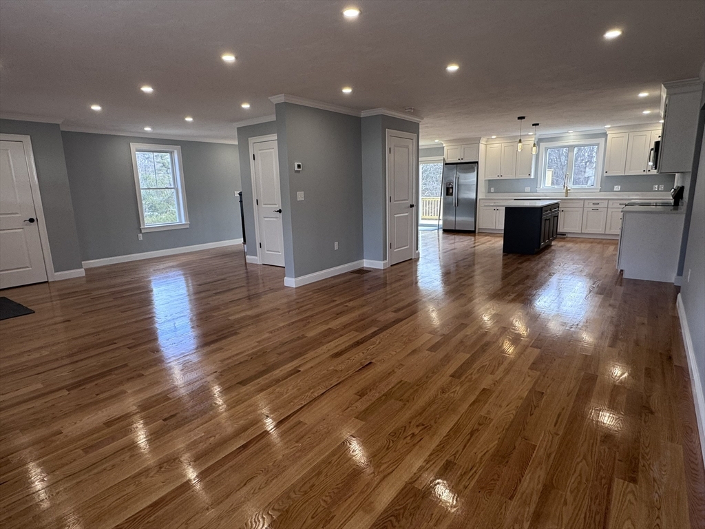193 East Spring Street Avon, MA 02322 - Photo 6 of 27 a view of a big room with wooden floor and windows