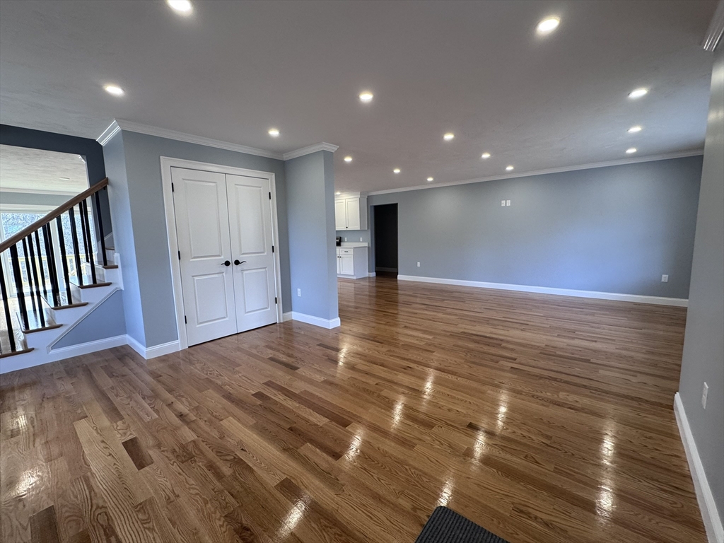 193 East Spring Street Avon, MA 02322 - Photo 7 of 27 a view of a hallway with wooden floor
