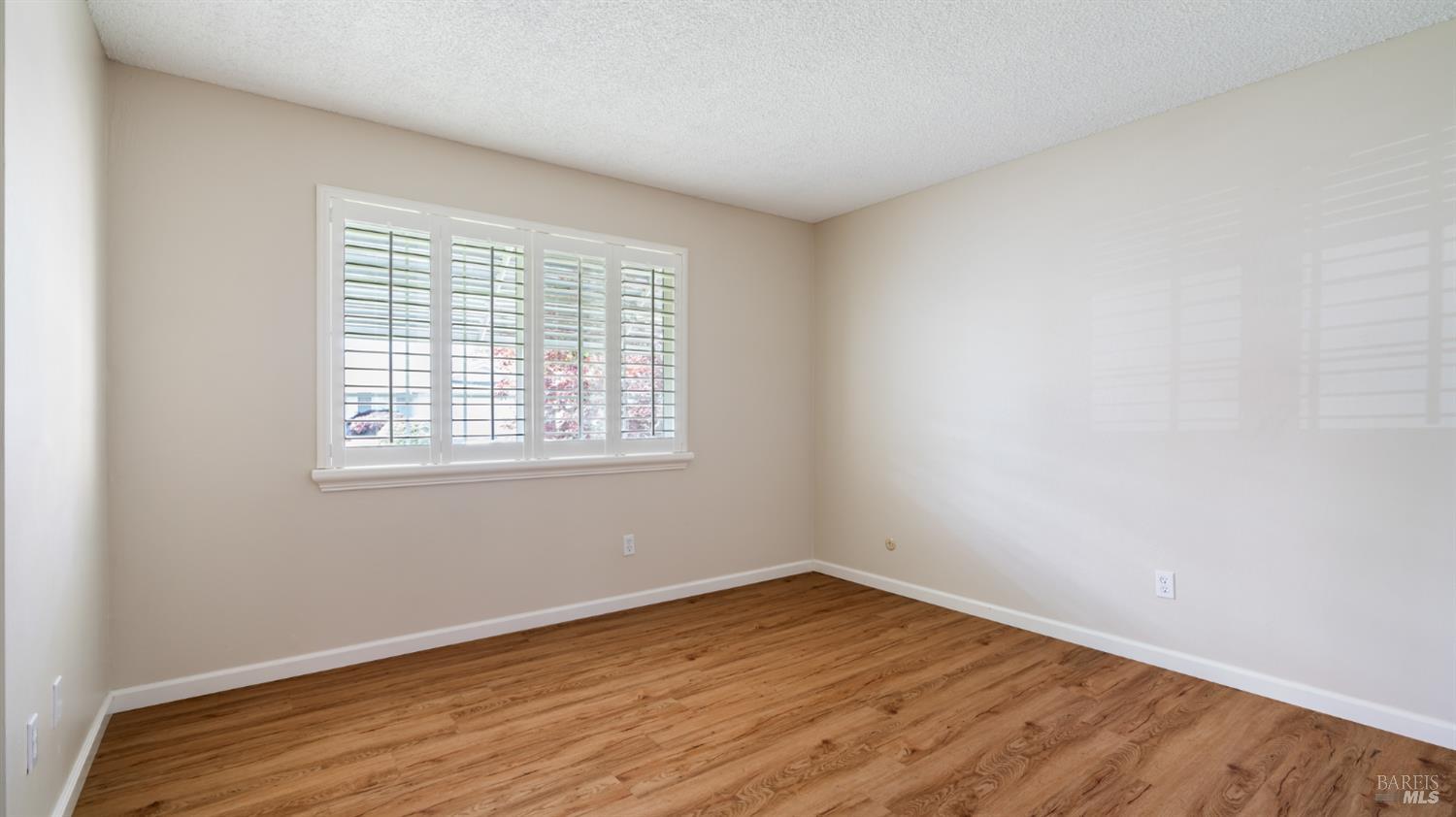 1536 Sunview Court Santa Rosa, CA 95401 - Photo 13 of 28 wooden floor in an empty room with a window