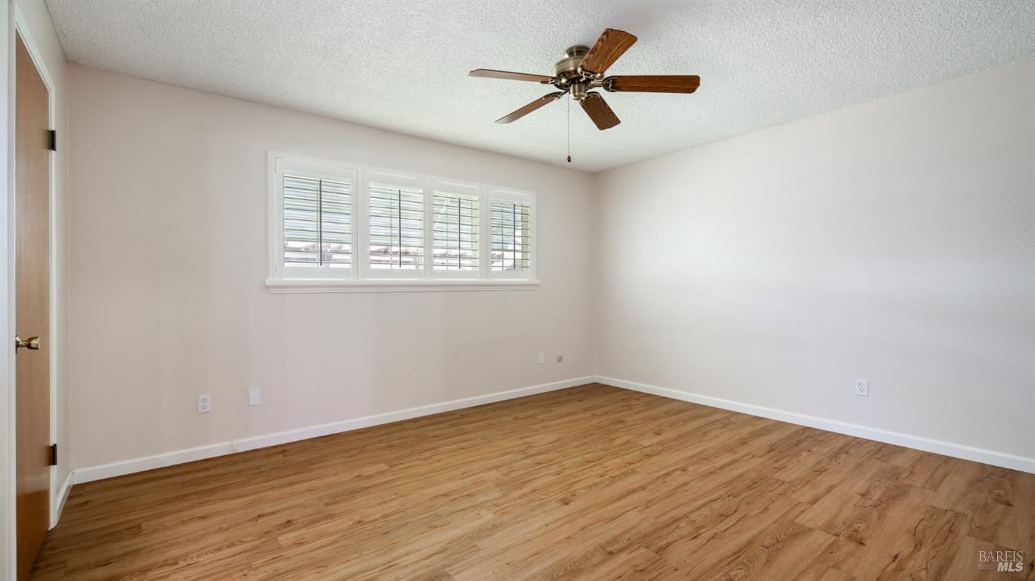 1536 Sunview Court Santa Rosa, CA 95401 - Photo 16 of 28 an empty room with wooden floor and windows