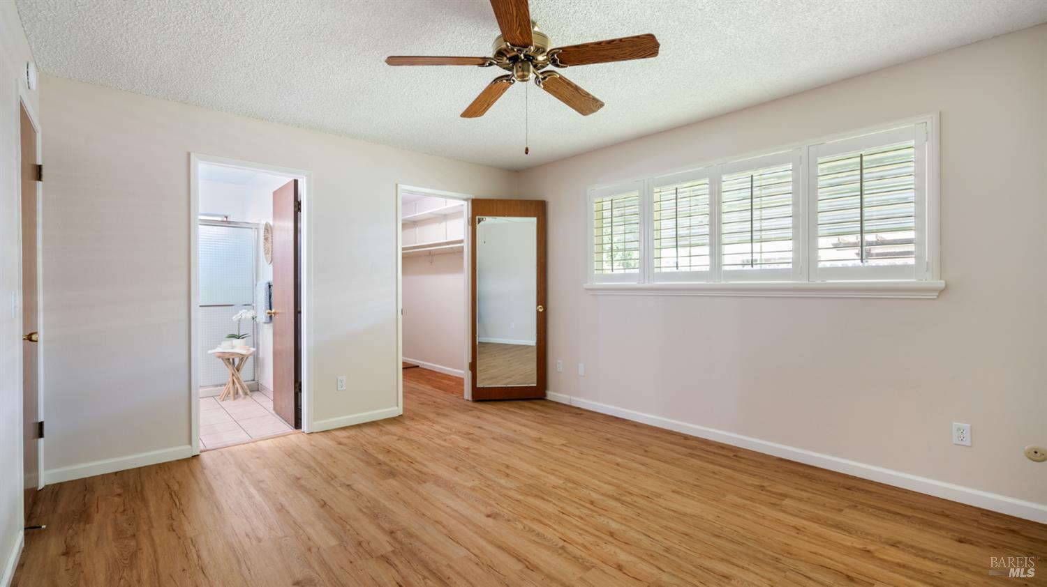 1536 Sunview Court Santa Rosa, CA 95401 - Photo 17 of 28 a view of an empty room with window and wooden floor