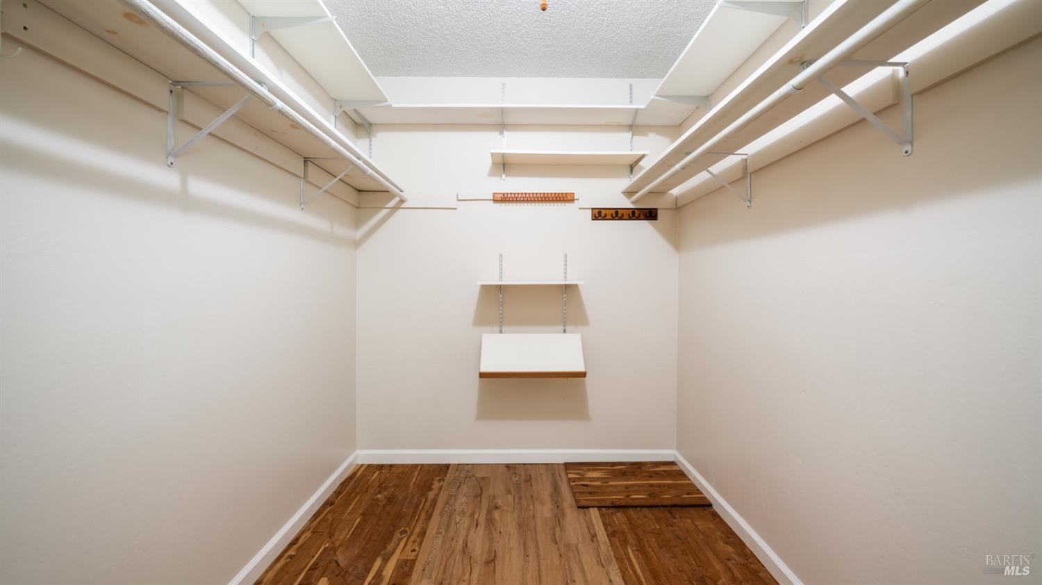1536 Sunview Court Santa Rosa, CA 95401 - Photo 18 of 28 a view of a hallway with wooden floor and a cabinet