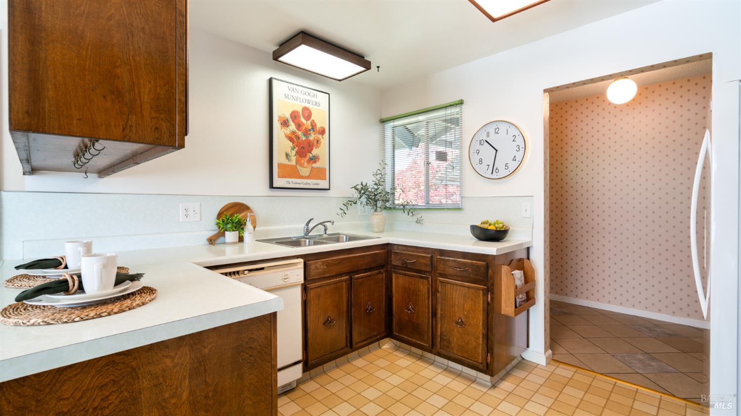 1536 Sunview Court Santa Rosa, CA 95401 - Photo 3 of 28 a kitchen with stainless steel appliances a sink a refrigerator and wooden cabinets