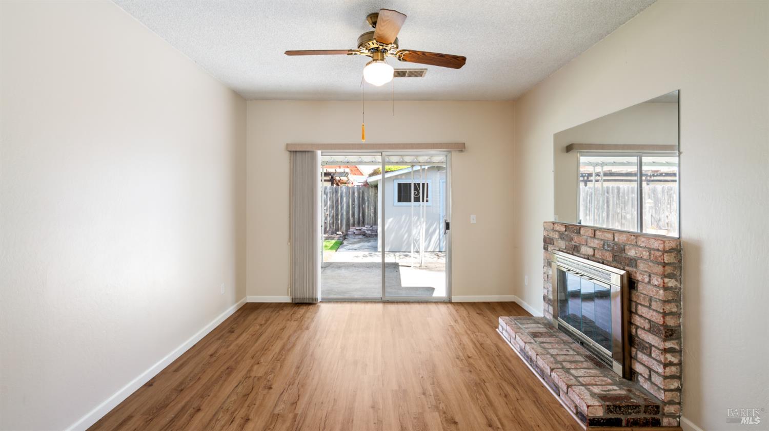 1536 Sunview Court Santa Rosa, CA 95401 - Photo 9 of 28 a view of empty room with wooden floor and fireplace