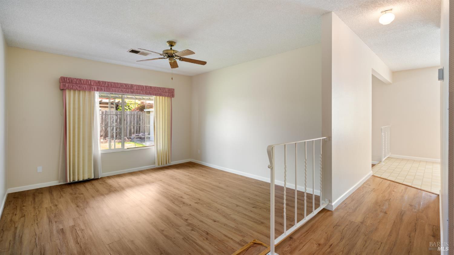 1536 Sunview Court Santa Rosa, CA 95401 - Photo 10 of 28 a view of an empty room with wooden floor and a window