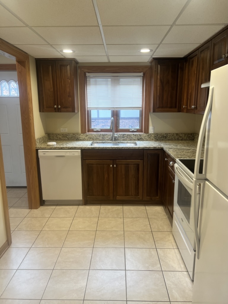 1988 Green Bay Road, Unit 1 Highland Park, IL 60035 - Photo 3 of 13 a kitchen with a sink a stove top oven and cabinets