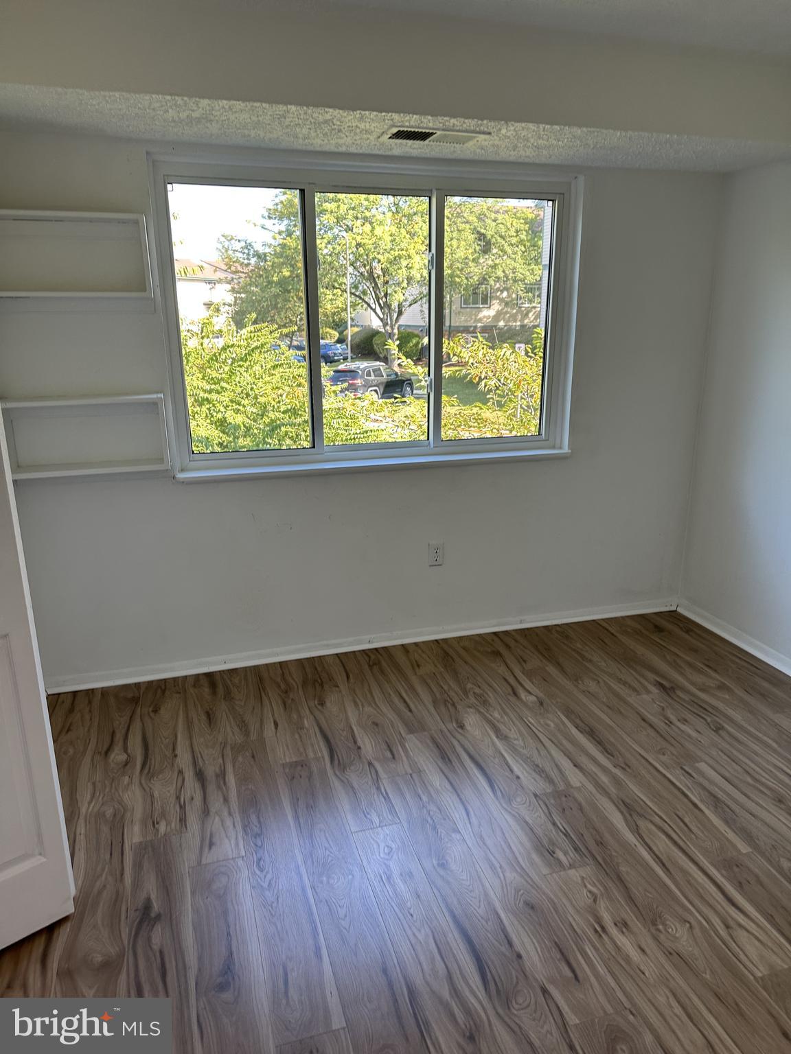 19525 Gunners Branch Road, Unit G Germantown, MD 20876 - Photo 16 of 21 an empty room with wooden floor and windows