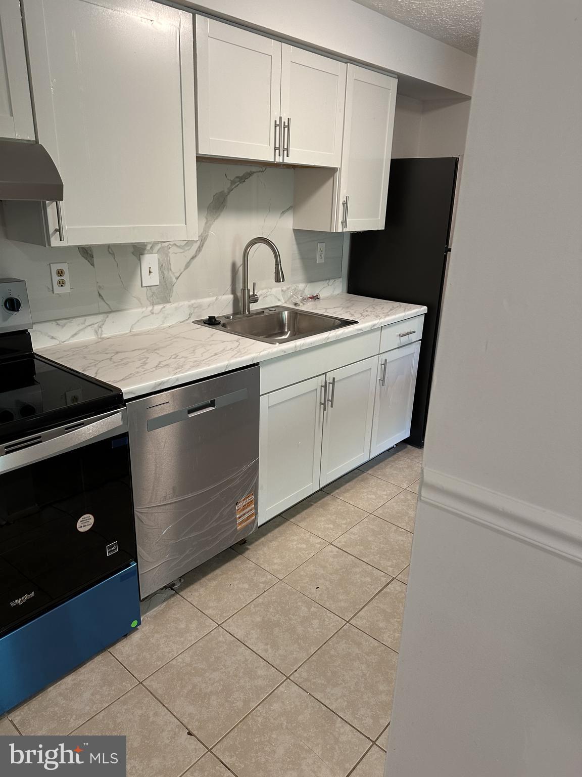 19525 Gunners Branch Road, Unit G Germantown, MD 20876 - Photo 9 of 21 a kitchen with a sink and a stove top oven