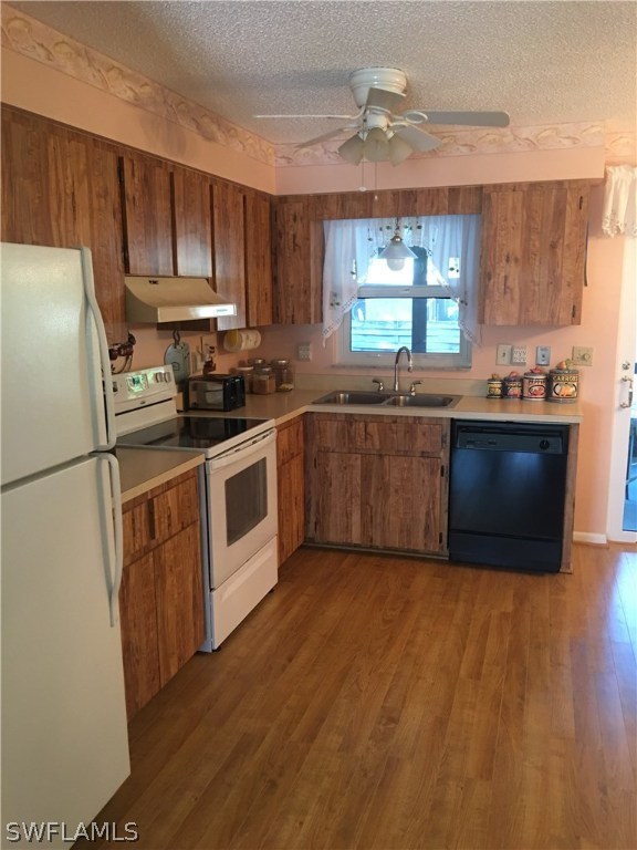 7259 Buchanan Road Fort Myers, FL 33967 - Photo 1 of 13 a kitchen with granite countertop stainless steel appliances a sink cabinets and a window