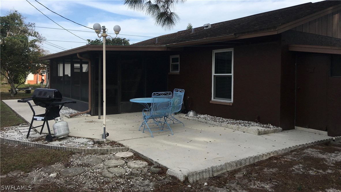 7259 Buchanan Road Fort Myers, FL 33967 - Photo 13 of 13 a backyard of a house with table and chairs