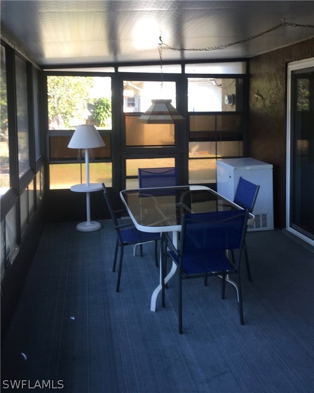 7259 Buchanan Road Fort Myers, FL 33967 - Photo 2 of 13 a view of a workspace with furniture and a window