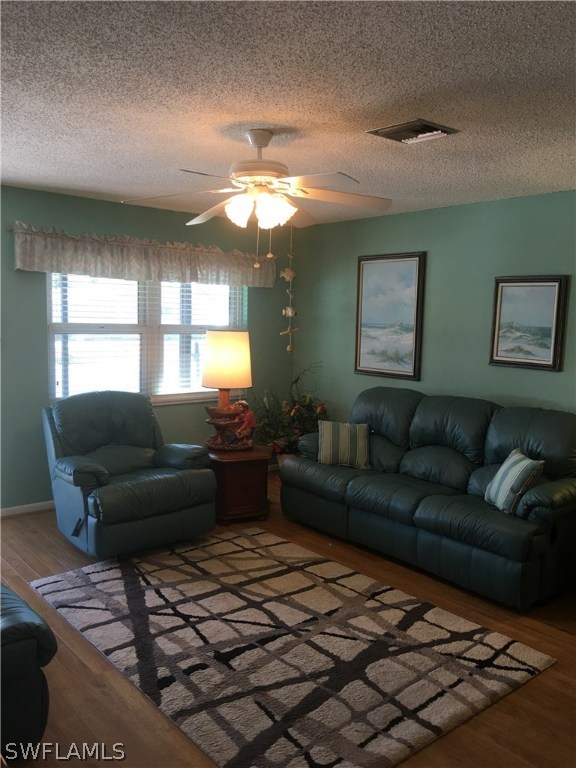 7259 Buchanan Road Fort Myers, FL 33967 - Photo 4 of 13 a living room with furniture and a large window