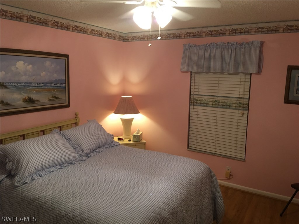 7259 Buchanan Road Fort Myers, FL 33967 - Photo 10 of 13 a bed room with a bed and a painting on the wall