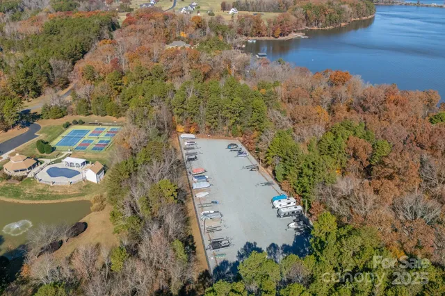an aerial view of a house with a yard and lake view
