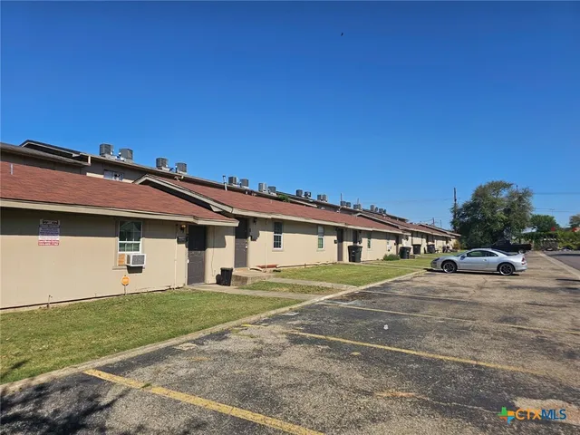 a front view of a house with a garden and yard