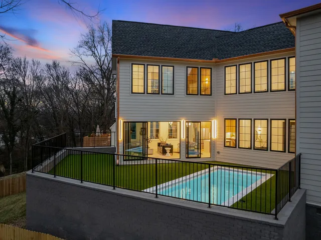 a bedroom with furniture and a large window