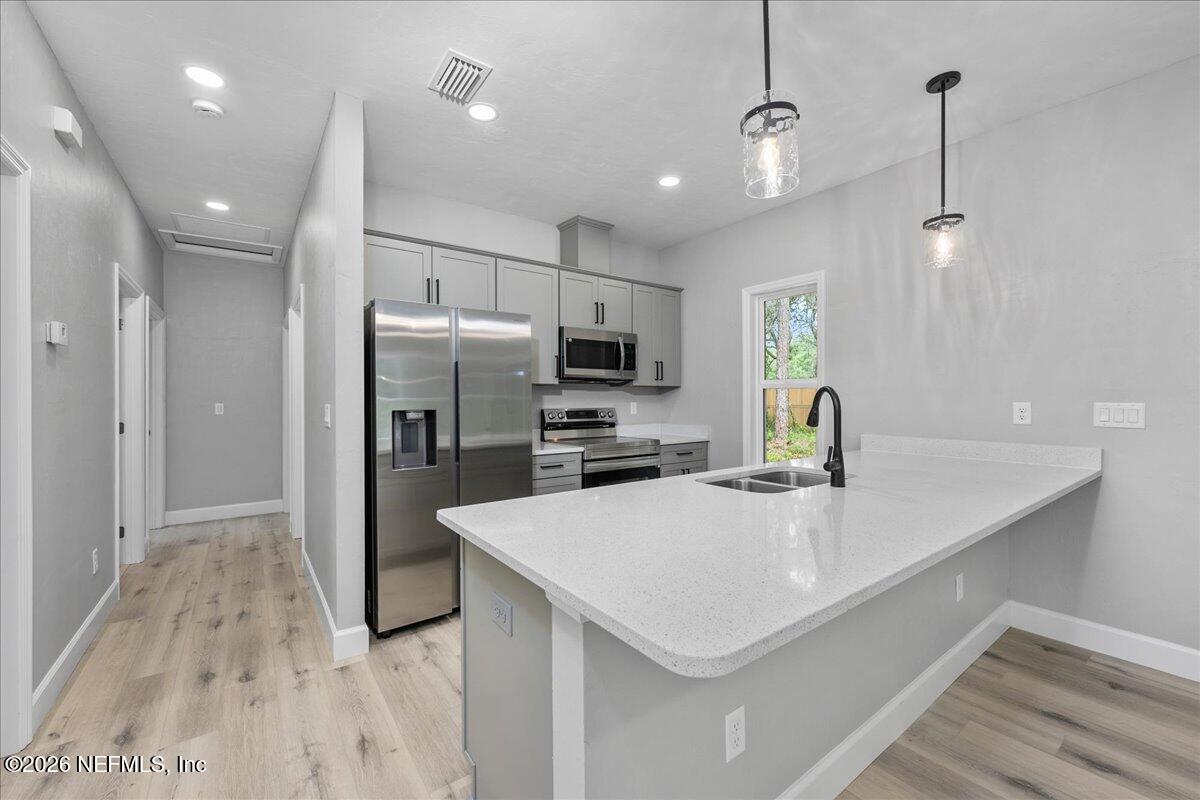 108 Pamela Street Interlachen, FL 32148 - Photo 13 of 31 a kitchen with a sink a counter space appliances and cabinets
