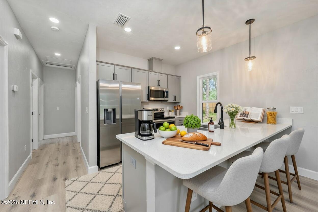 108 Pamela Street Interlachen, FL 32148 - Photo 14 of 31 a kitchen with a sink a refrigerator and chairs