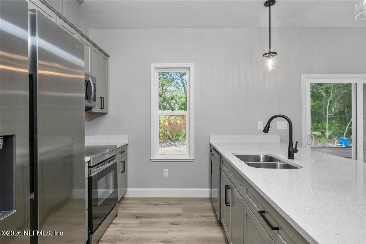 108 Pamela Street Interlachen, FL 32148 - Photo 15 of 31 a kitchen with stainless steel appliances granite countertop a sink a stove and a refrigerator