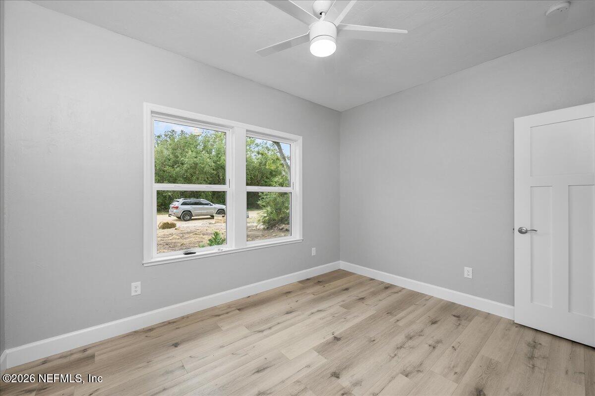 108 Pamela Street Interlachen, FL 32148 - Photo 18 of 31 an empty room with wooden floor and windows