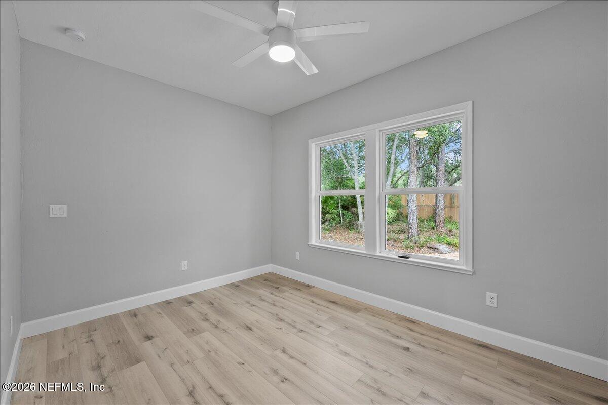 108 Pamela Street Interlachen, FL 32148 - Photo 19 of 31 an empty room with wooden floor and windows