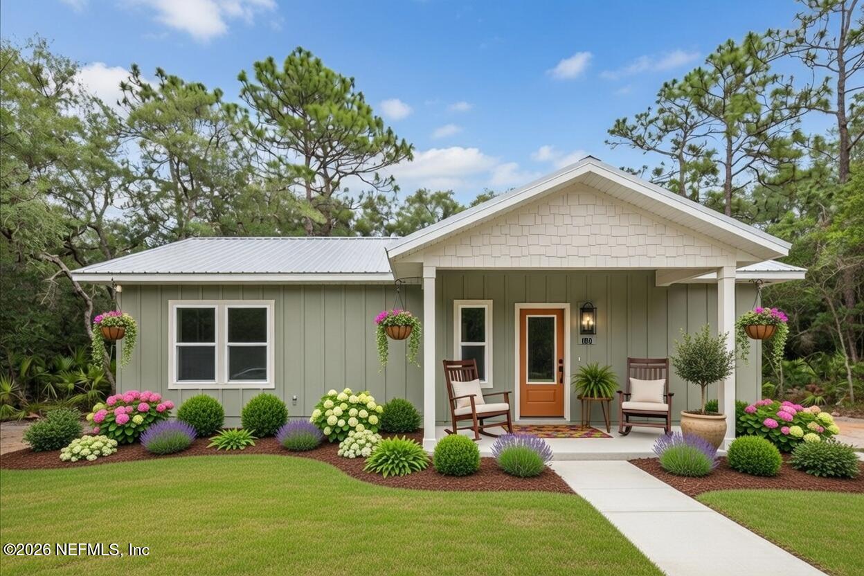 108 Pamela Street Interlachen, FL 32148 - Photo 3 of 31 a front view of a house with a garden and plants