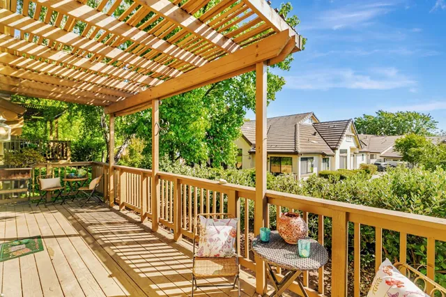 a view of a balcony with chairs and wooden floor