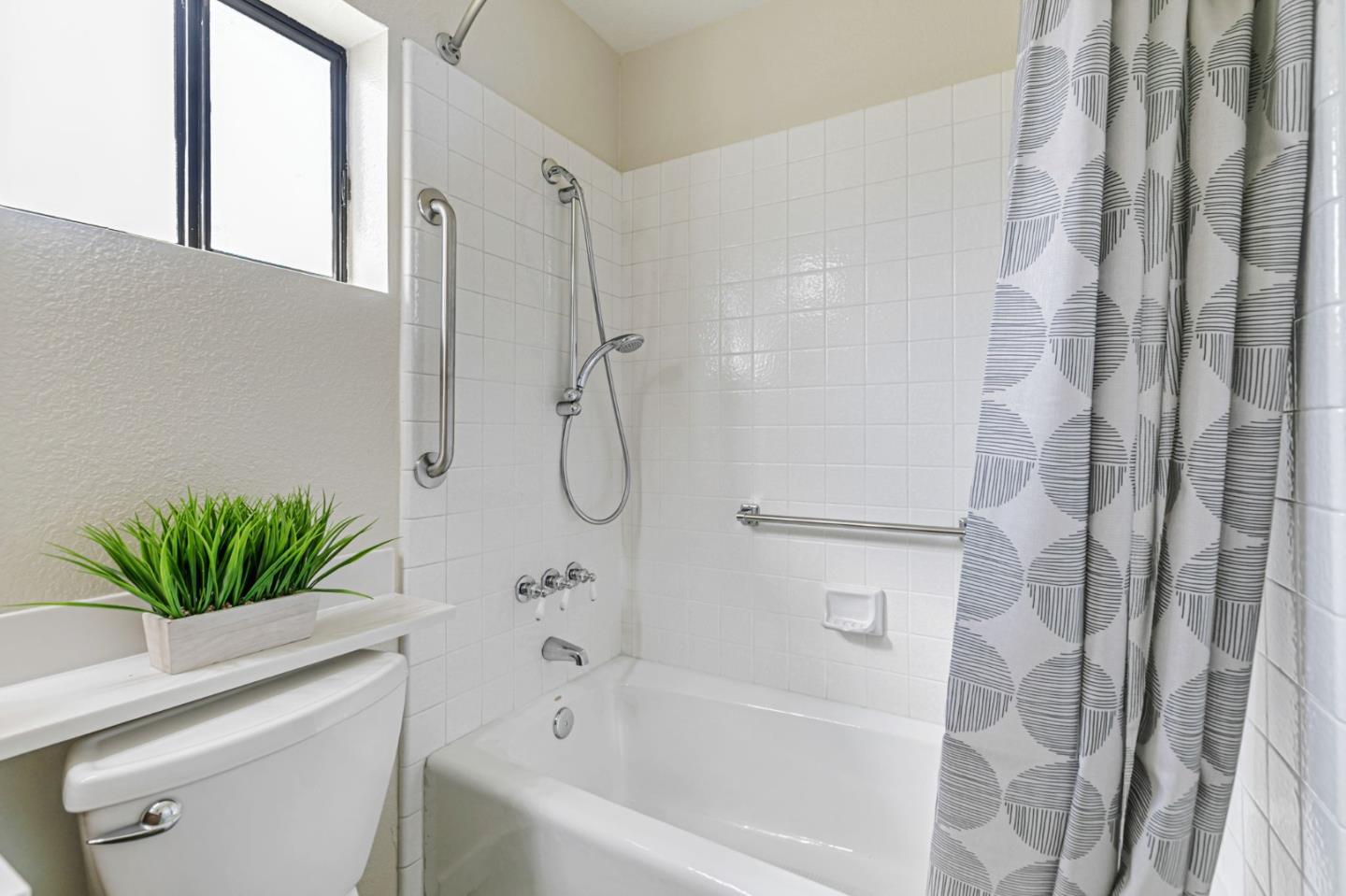 7530 Morevern Circle San Jose, CA 95135 - Photo 31 of 41 a bathroom with a shower curtain a sink and a mirror