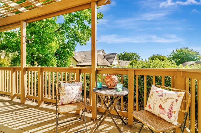 a roof deck with table and chairs and wooden floor