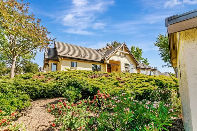 a view of a house with a small yard and plants