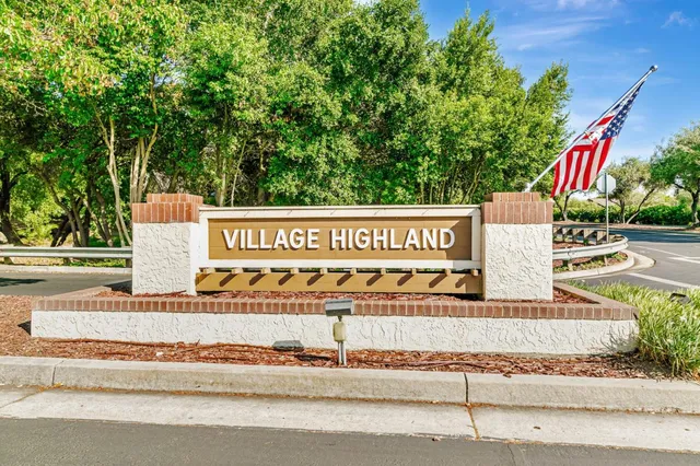 a view of a street with houses in the background