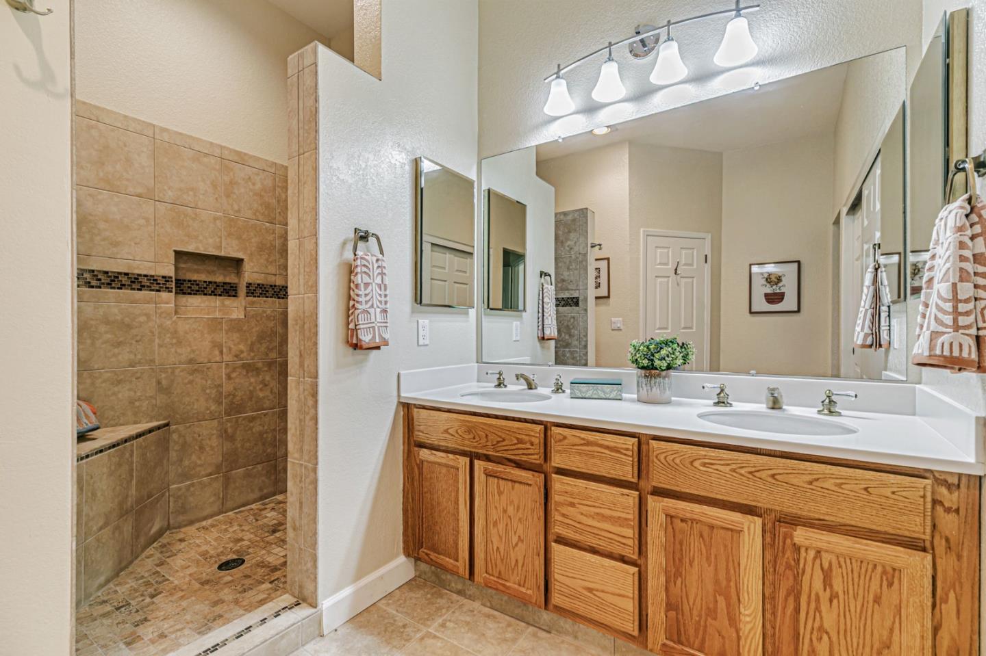7530 Morevern Circle San Jose, CA 95135 - Photo 7 of 41 a bathroom with a double vanity sink mirror and shower