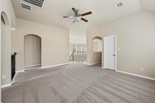 a view of an empty room with a ceiling fan