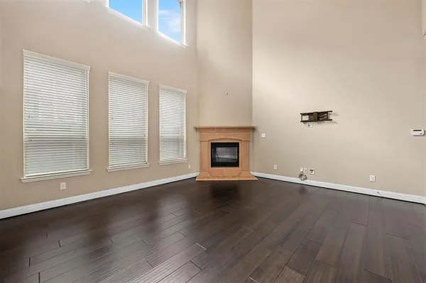 an empty room with wooden floor and a window