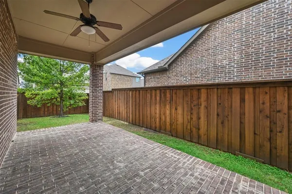 a view of a backyard with wooden fence