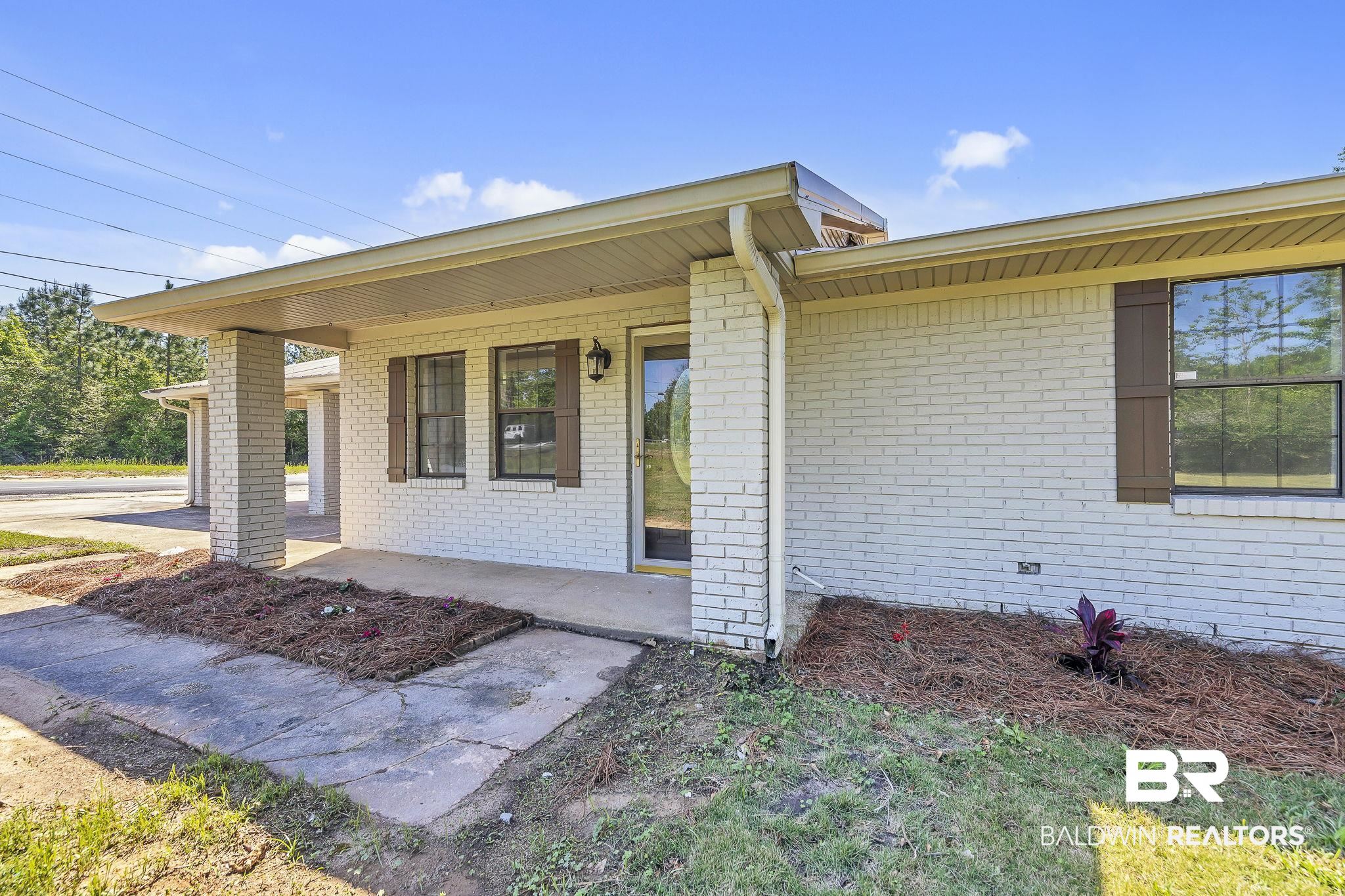 11964 Stroh Road Daphne, AL 36527 - Photo 9 of 58 View of front of property with a porch and brick siding