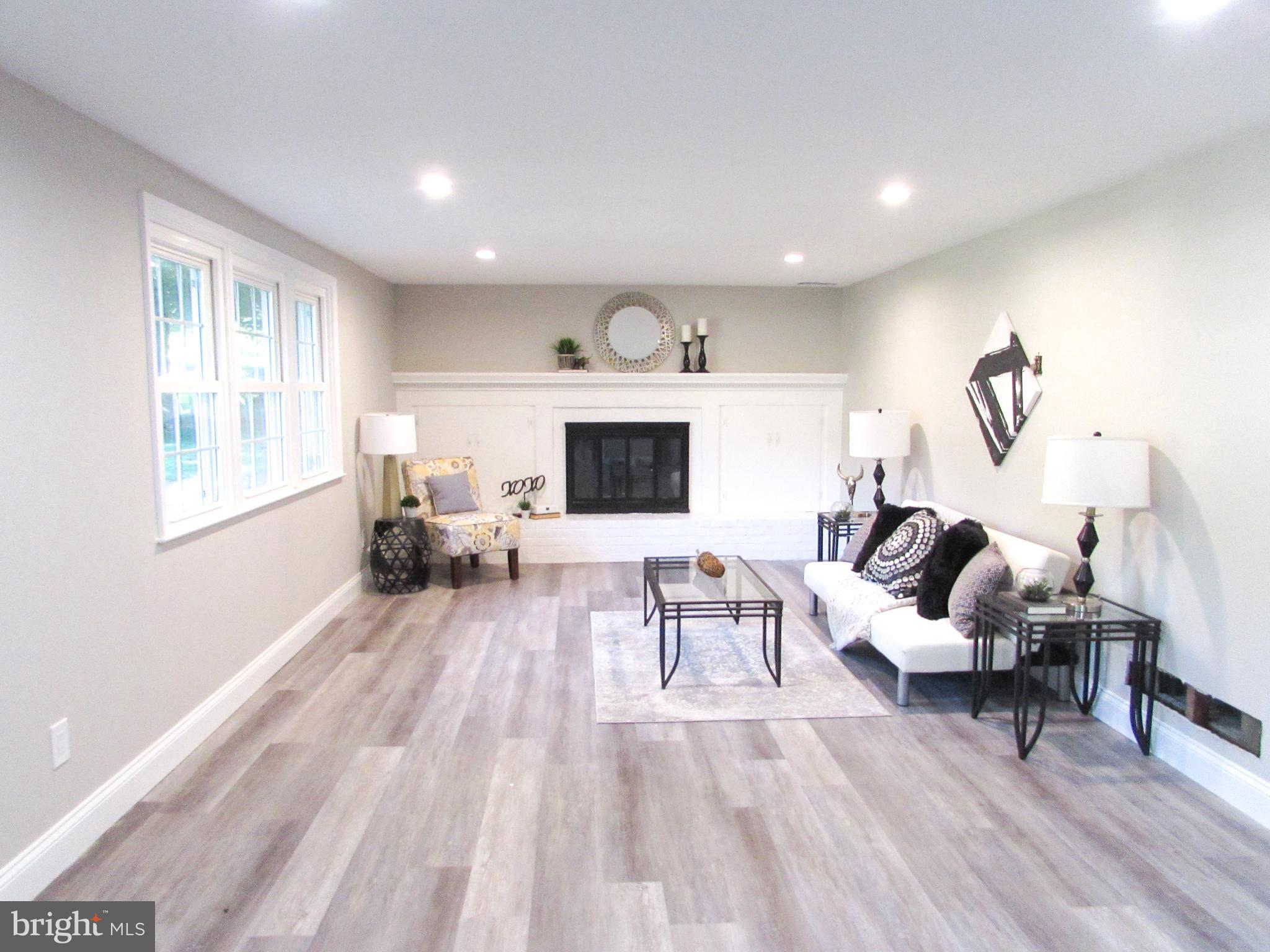 4729 Roundhill Road Ellicott City, MD 21043 - Photo 3 of 48 FINISHED MAIN LEVEL FAMILY RM WITH BRICK FIREPLACE