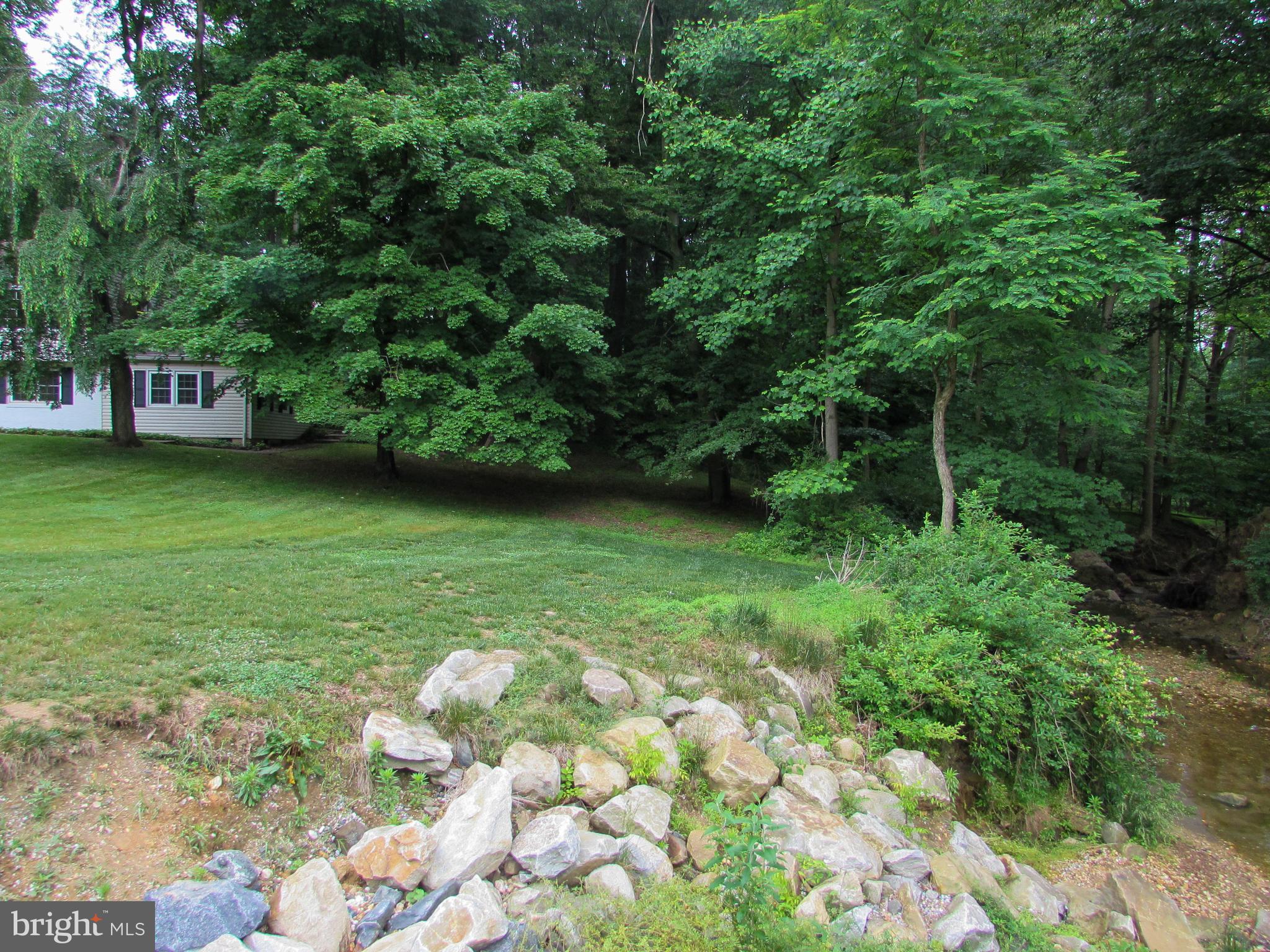 4729 Roundhill Road Ellicott City, MD 21043 - Photo 41 of 48 COMMUNITY STREAM BORDERS THE SIDE OF THE PROPERTY