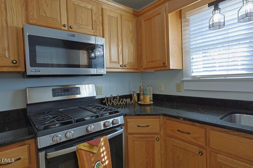 536 Oakgrove Road Asheboro, NC 27205 - Photo 11 of 36 a kitchen with granite countertop cabinets and a stove top oven