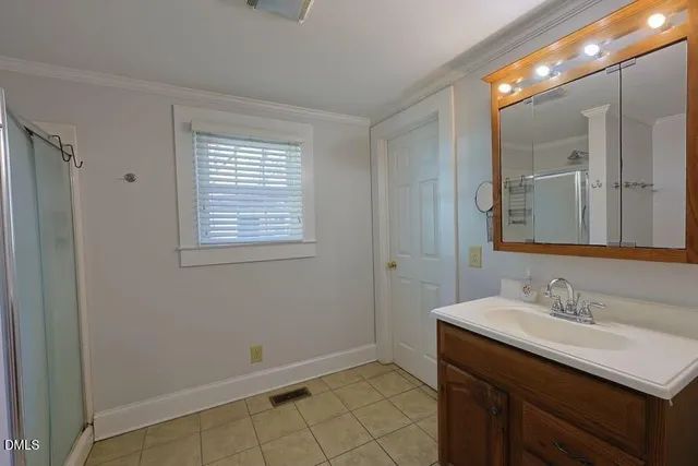 a bathroom with a sink vanity and a mirror