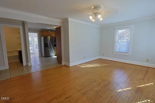 wooden floor in an empty room with a window
