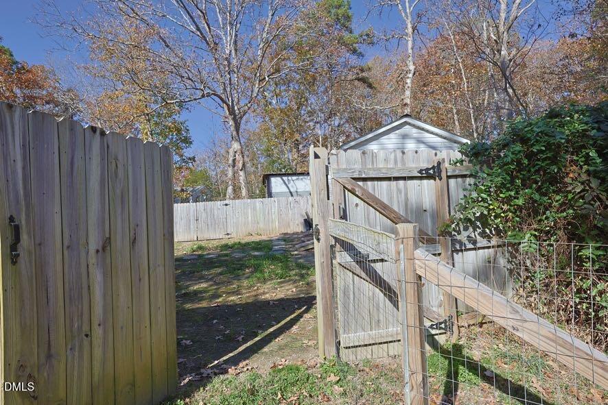 536 Oakgrove Road Asheboro, NC 27205 - Photo 34 of 36 a view of a house with a small yard and wooden fence