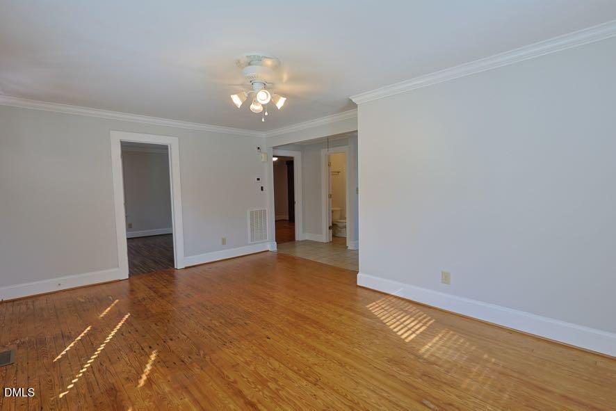 536 Oakgrove Road Asheboro, NC 27205 - Photo 4 of 36 a view of an empty room with wooden floor and a chandelier