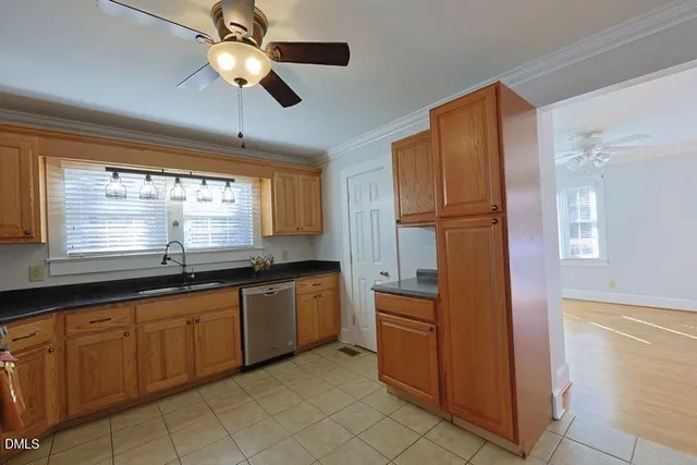 a kitchen with granite countertop a sink stainless steel appliances and cabinets