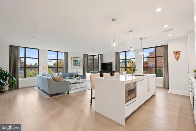 a view of living room with furniture and large windows