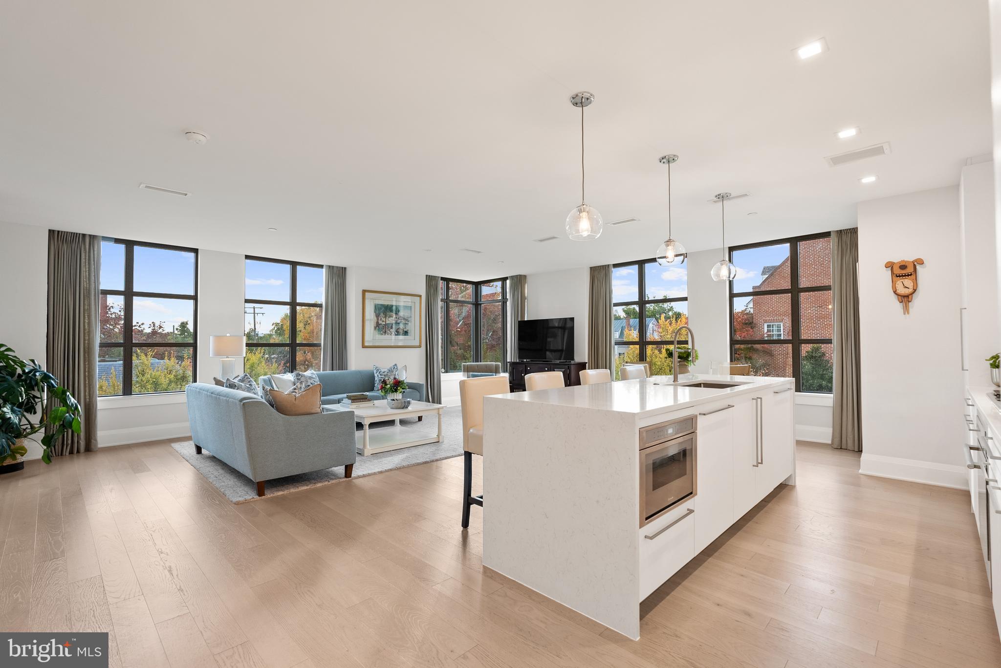 a view of living room with furniture and large windows
