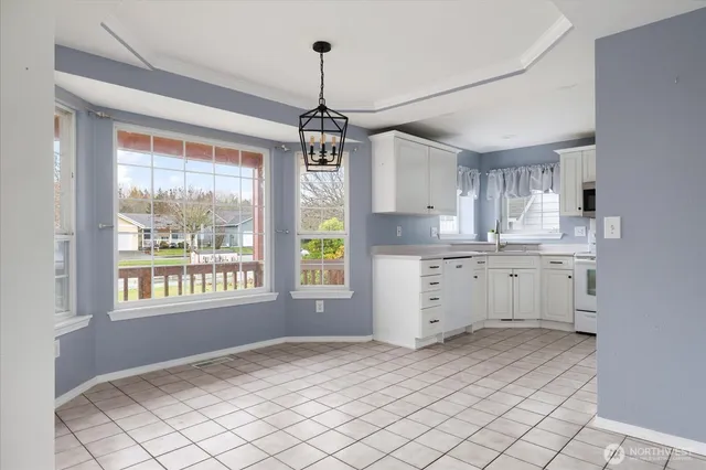 a kitchen with appliances a sink and a window