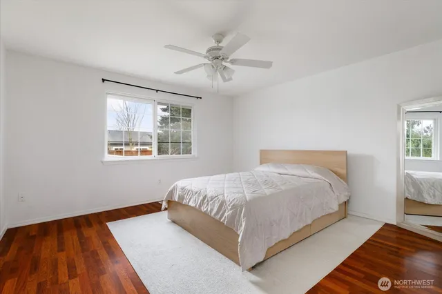a bathroom with a sink toilet a mirror and shower curtain