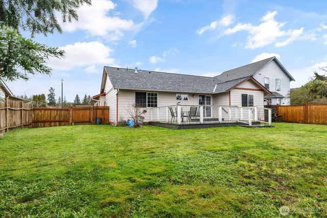 a view of a house with backyard and porch