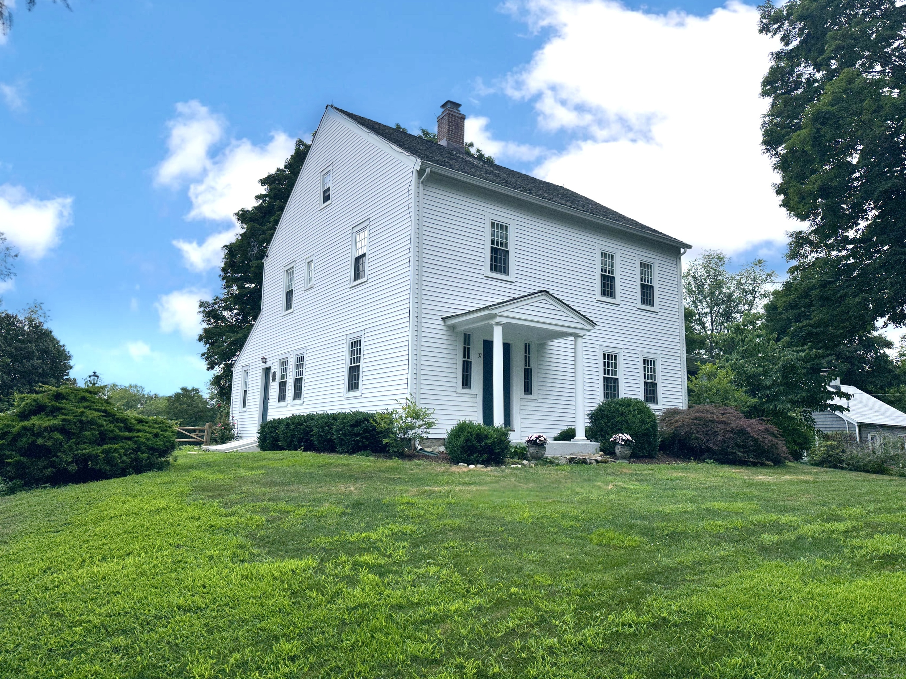 a front view of a house with a garden